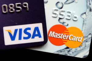 &ldquo;Close-up of multiple Visa and Mastercard credit cards placed on a computer keyboard, representing online payments, chargebacks and Section 75 disputes