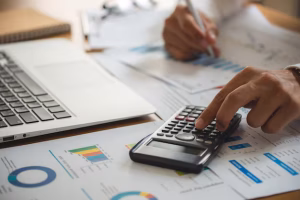 Businessman reviewing legal documents and comparing costs