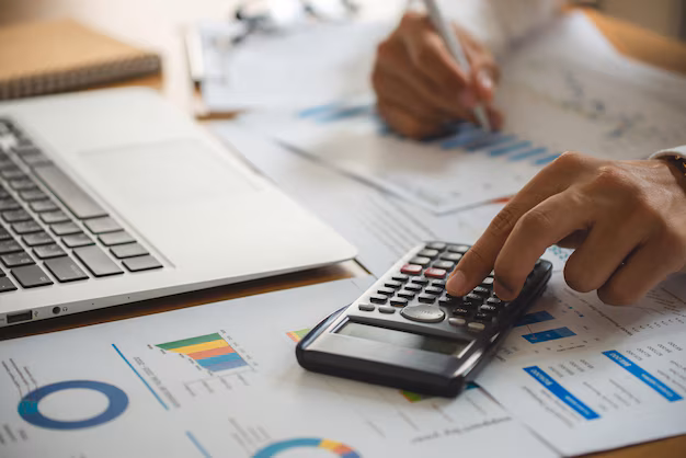 Businessman reviewing legal documents and comparing costs