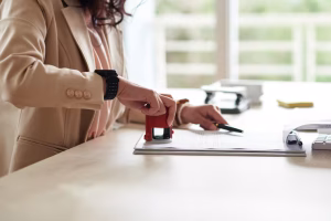 Certified legal documents being stamped on a law office desk, illustrating solicitor regulation and document verification.