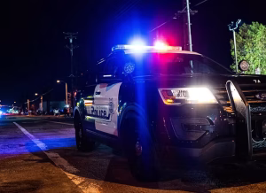 San Bernardino County sheriff vehicle with emergency lights at night