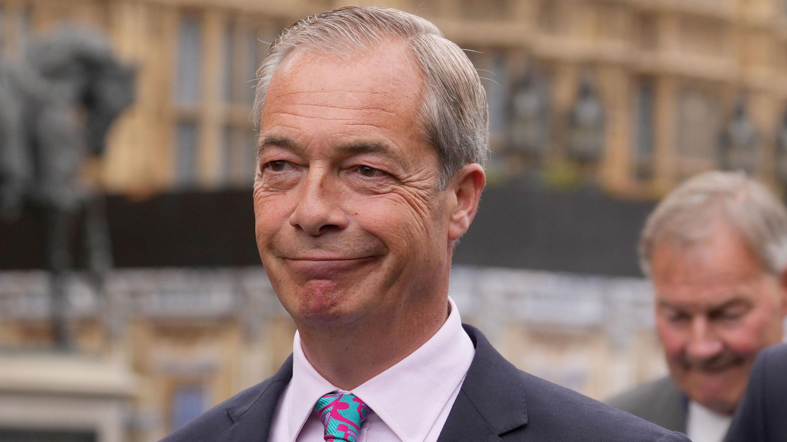Nigel Farage pictured outside the Houses of Parliament following scrutiny over undeclared income and parliamentary rule breaches.
