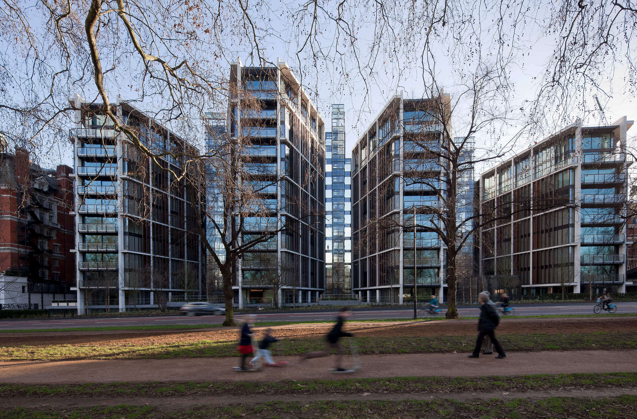 Exterior view of the One Hyde Park residential development in London, showing modern glass-fronted apartment buildings facing Hyde Park.