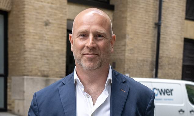 A former company executive outside a London building following court proceedings.