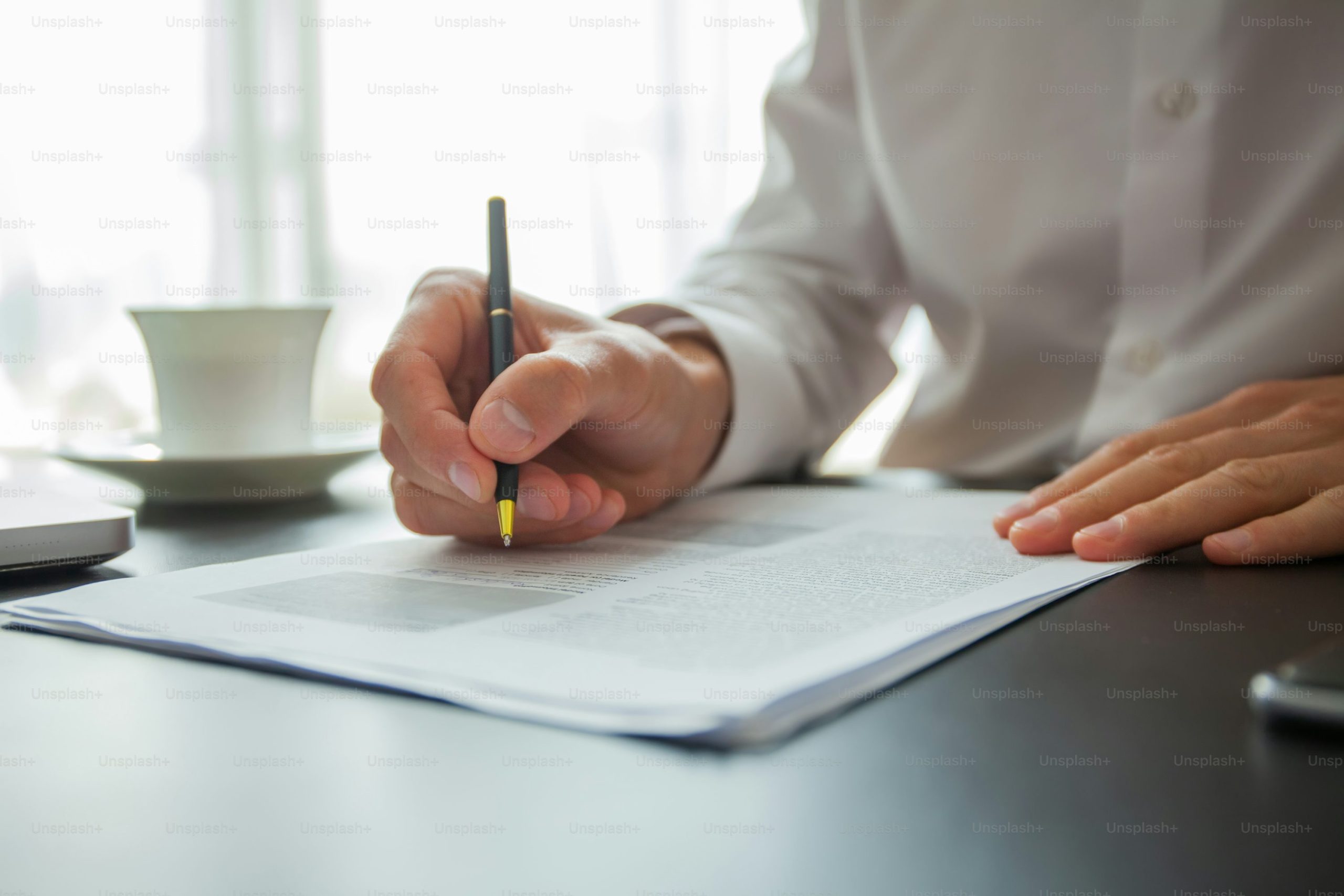 A freelancer signing a contract at their workspace