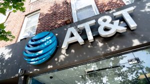 Exterior AT&T store signage with the company&rsquo;s blue globe logo on a brick building.