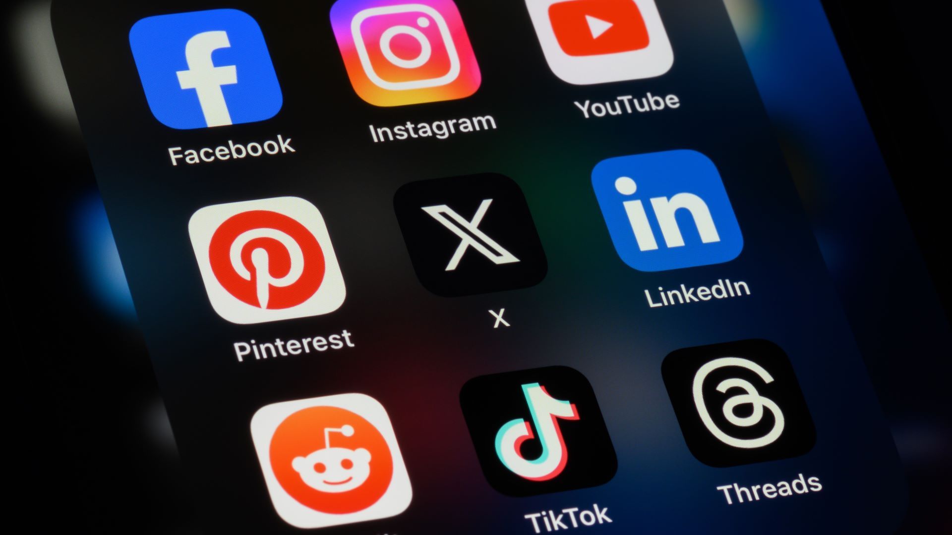 Smartphone screen displaying major social media platform icons, illustrating how online posts can create legal and reputational risk.