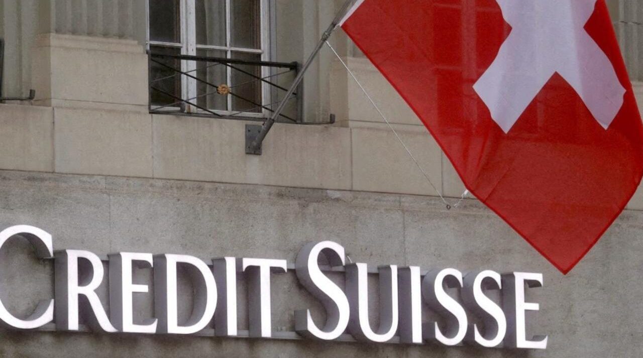 Credit Suisse branch in Switzerland with the Swiss flag, symbolizing renewed scrutiny over historical Nazi-era links