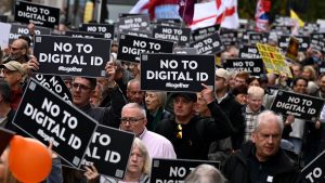 Protesters in the UK holding &ldquo;No to Digital ID&rdquo; signs during a public demonstration against mandatory digital identity policies