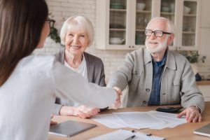 elderly reviews legal documents for power of attorney at home
