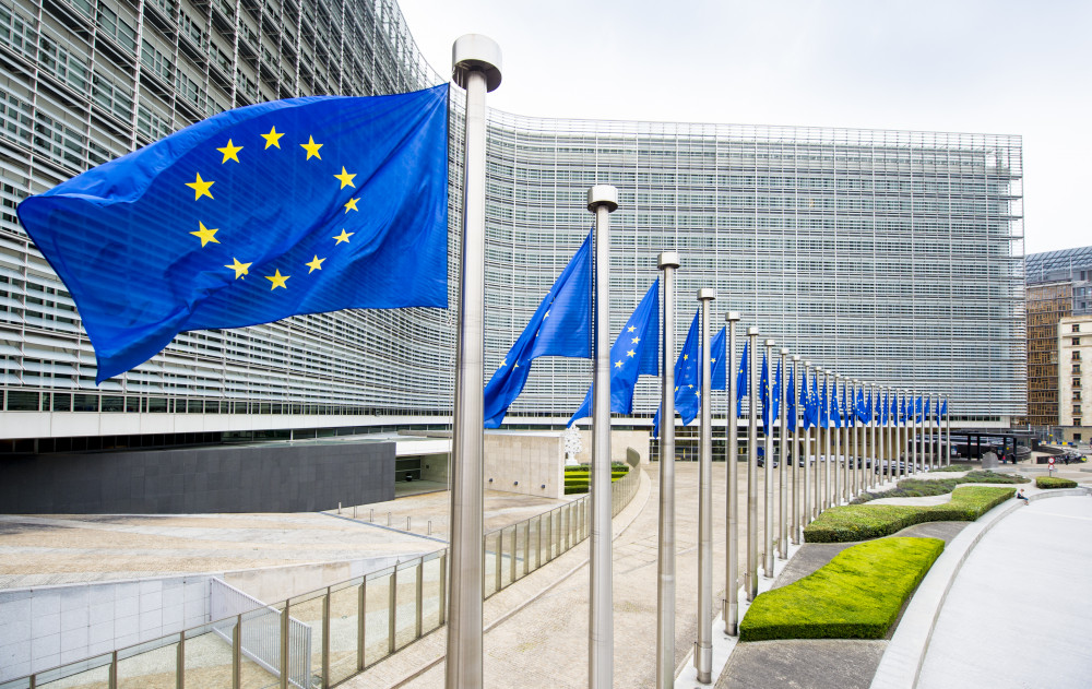 European Commission headquarters in Brussels with EU flags