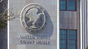Exterior of a United States courthouse featuring the federal eagle seal on the stone fa&ccedil;ade