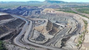 Aerial view of a large open-pit mining site, representing Glencore mining operations and 2026 critical minerals merger risk context.