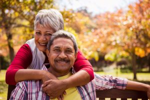 miling senior couple outdoors, representing New York&rsquo;s expanded 2026 property tax relief for older homeowners