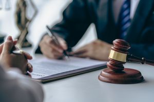 office with sledgehammer in front, lawyers and clients discussing court issues or justice at meeting law and order. the concept of courts and legislatures