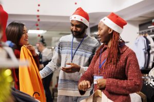 workers aiding client in buying items