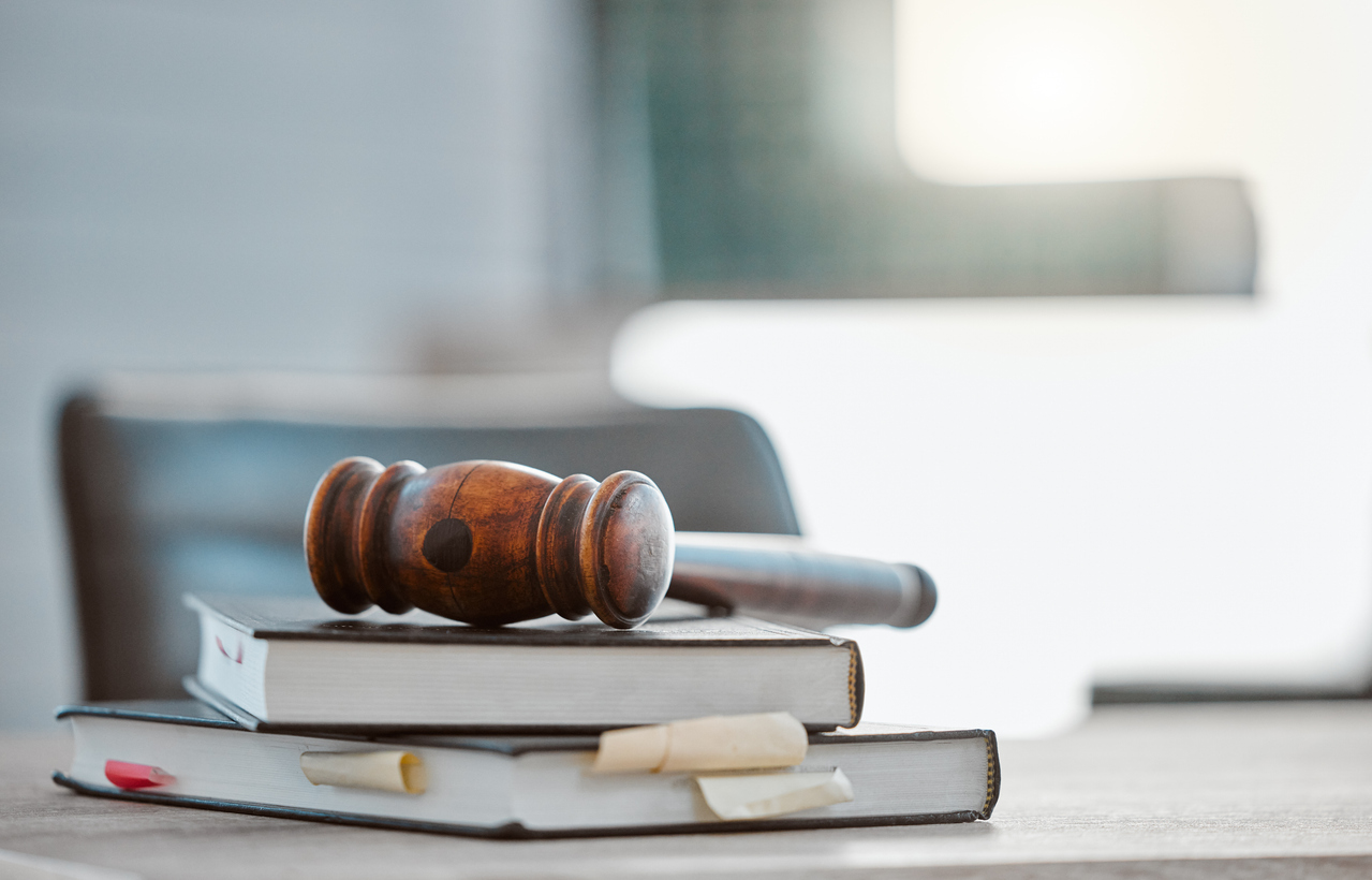 justice, gavel and law books on table in office for court trial, legislation or fair constitution by judicial system. firm, closeup and legal hammer by information for corporate case in workplace.