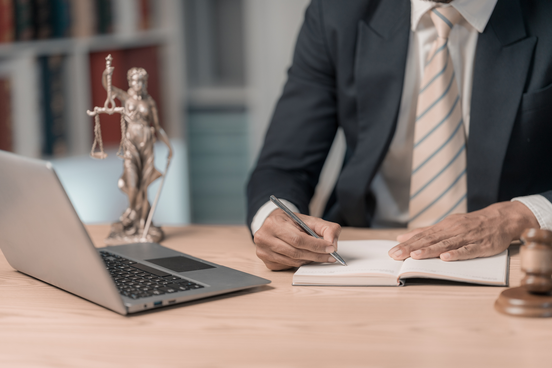 lawyers working with documents law, advice and justice concept, lawyer in suit signing legal document at table with justice scale, close up