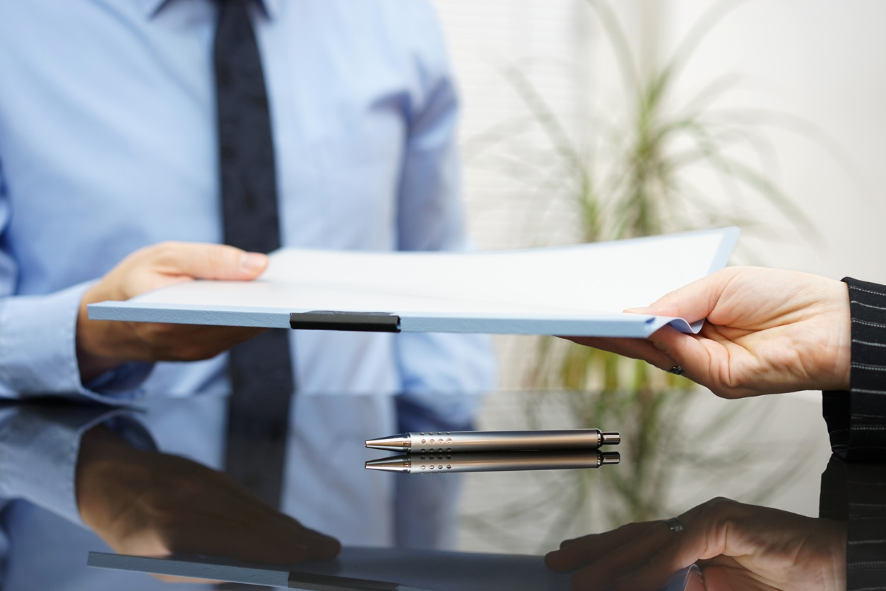 businessman is passing signed agreement to client after successful negotiation