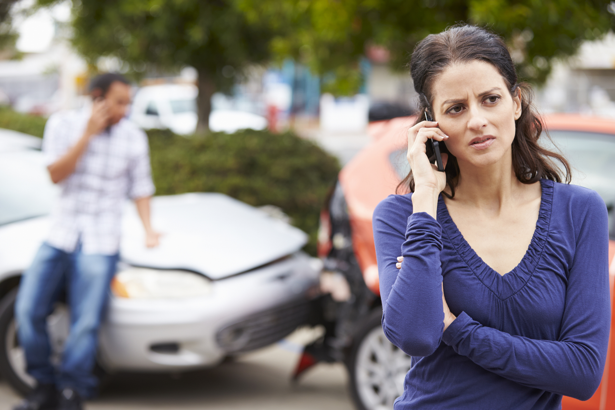 female driver making phone call after traffic accident