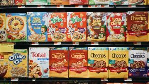 Supermarket aisle with packaged snacks and cereal products on shelves
