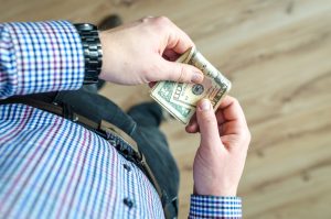 Counting cash. U.S. dollars and property tax bill illustrating New York&rsquo;s 2026 cash law and senior tax exemption.