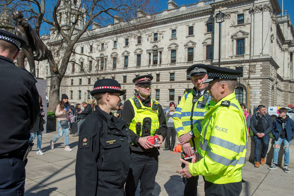 UK police officers on a high-visibility patrol speaking with members of the public in central London