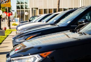 Row of cars at a dealership illustrating Georgia&rsquo;s 2026 temporary tag law targeting fraudulent &lsquo;ghost dealers.