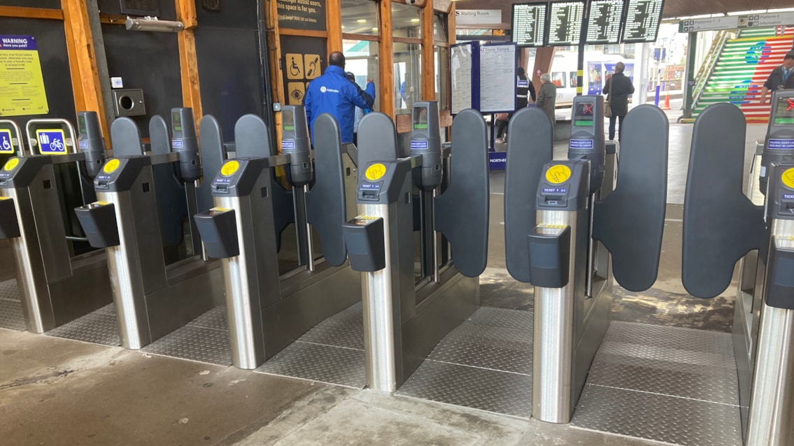 UK train station ticket barriers at a railway entrance